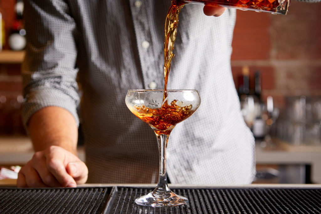 Bartender serving a Rye of the Tiger cocktail