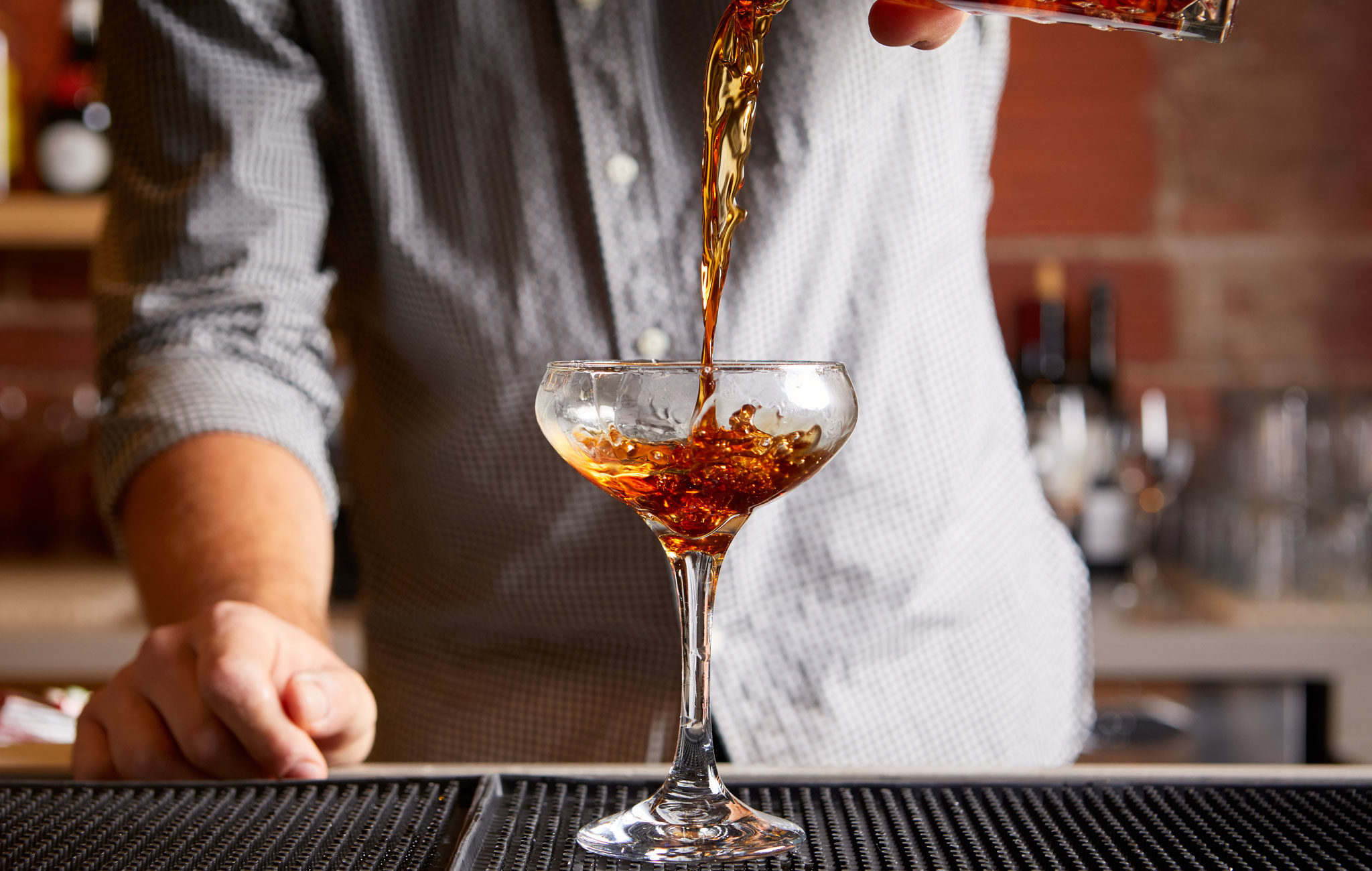 Bartender serving a Rye of the Tiger cocktail