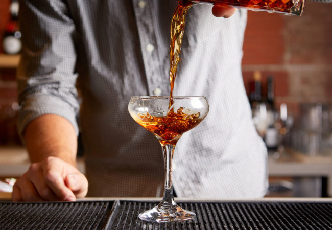 Bartender serving a Rye of the Tiger cocktail
