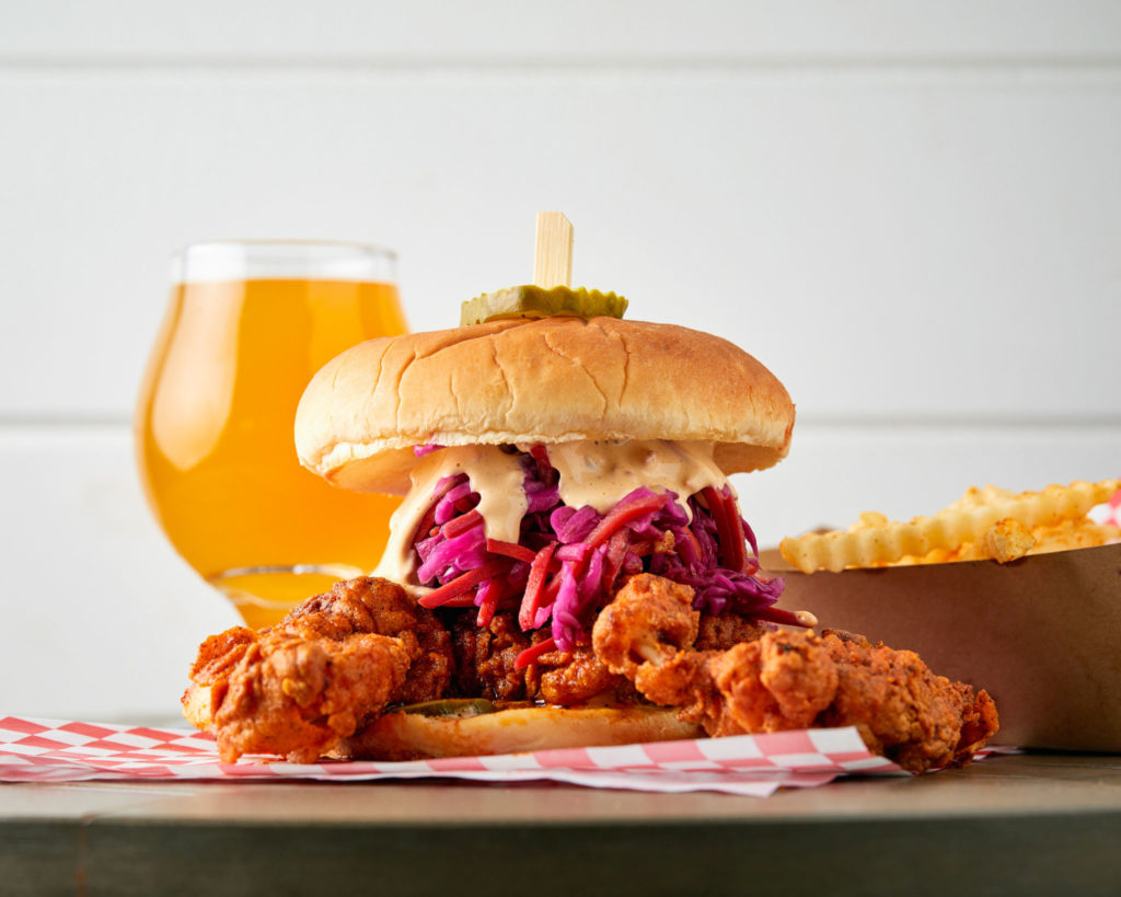 Fried chicken sandwich, fries, and a beer