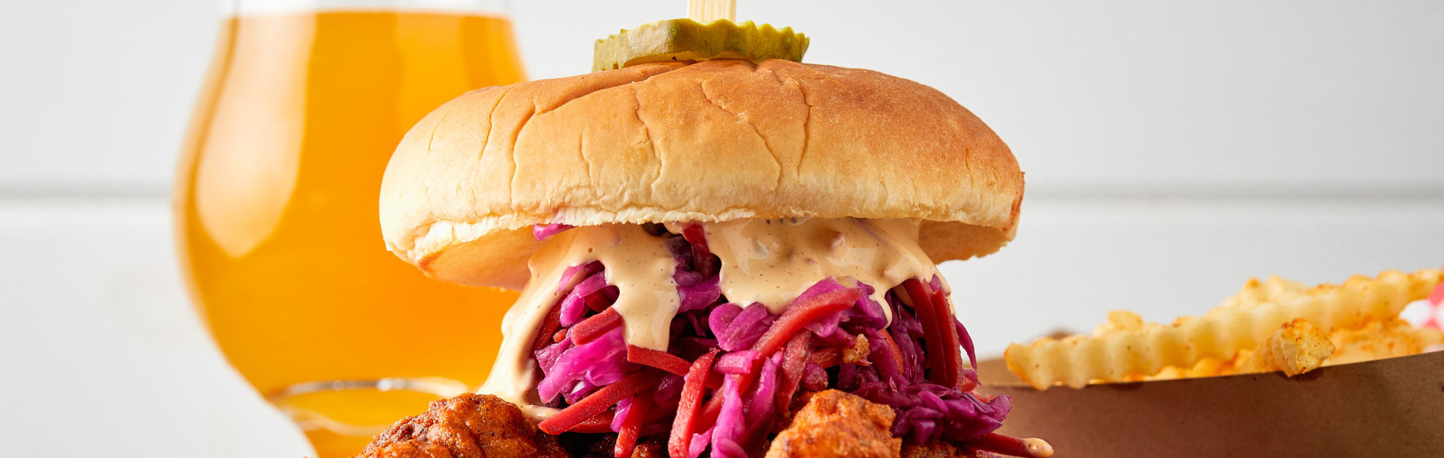 Fried chicken sandwich, fries, and a beer