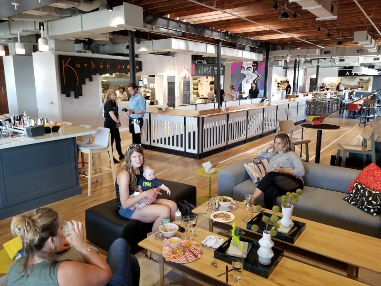 People sitting on couches inside Parlor