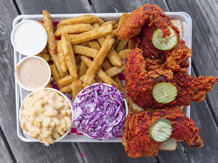 Plate of chicken, coleslaw, and fries