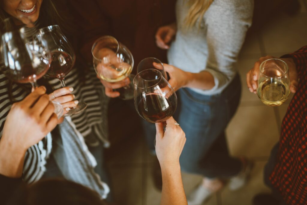 A group of woman having a cheers with wine glasses