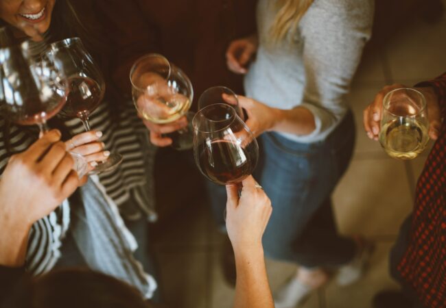 A group of woman having a cheers with wine glasses